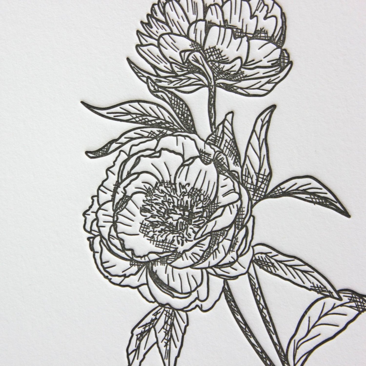 Close up of deep letterpress impression in cotton paper