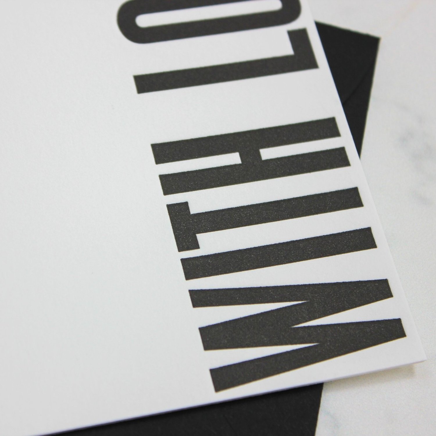 Bold letterpress type pressed into cotton paper